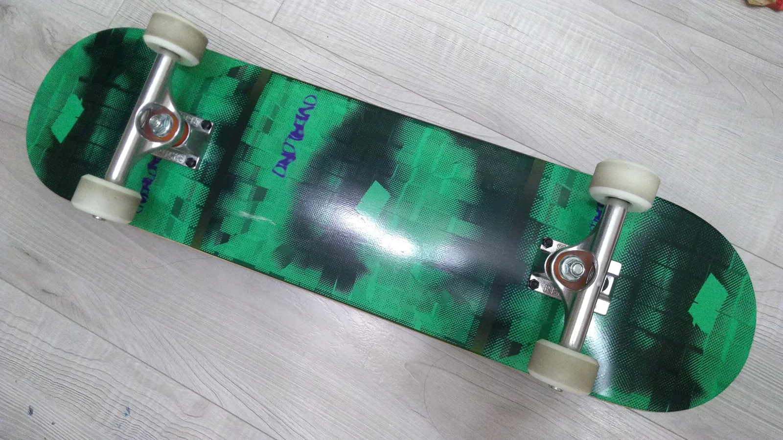 The underside of a skateboard photographed outdoors